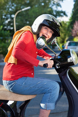Naklejka premium Senior woman riding her scooter.