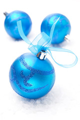 three blue Christmas balls, close-up, isolated on white