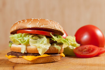 Delicious hamburgers on a wooden table.