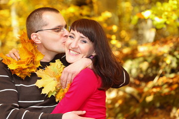 Fototapeta premium Portrait of young man kissing his girlfriend