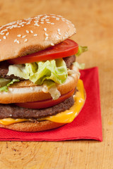 Delicious hamburgers on a wooden table.
