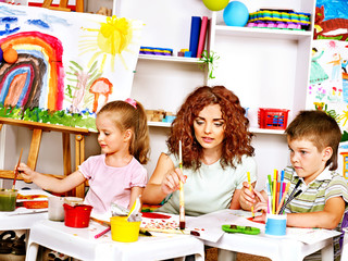 Child painting with mum.