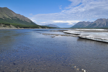 Sunny landscape of the river in mountains.