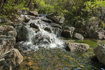 Fototapeta premium Small cascade waterfall by Palace hotel in Sun City