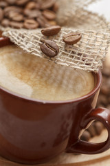 Cup of coffee with a close-up of grains
