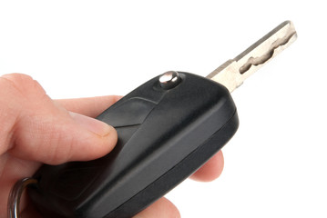 Hand holding car keys isolated on white background