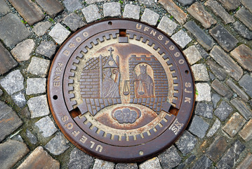 Sewer manhole on the stone pavement