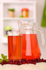 Pitcher and glass of cranberry juice with red cranberries