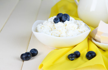 Fresh cottage cheese with blueberry on wooden table close-up