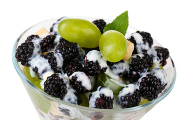 Fruit salad in glass bowl, isolated on white
