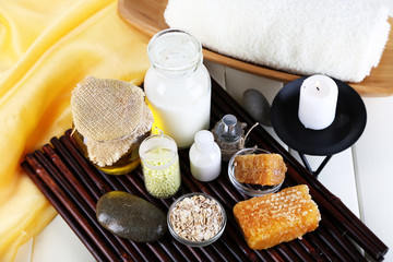 Honey and milk spa with oils and honey on wooden table close-up