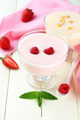 Delicious yogurt with berries on table close-up