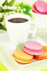 Coffee and macaroons on table close-up