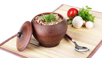Buckwheat in pot with  vegetables isolated on white