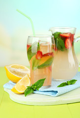 Basil lemonade with strawberry in  jug and glass,