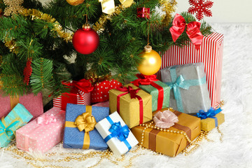 Decorated Christmas tree with gifts close-up