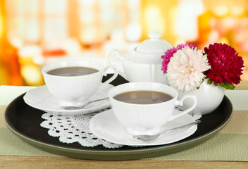 Fototapeta na wymiar Cups of tea on tray on table in cafe