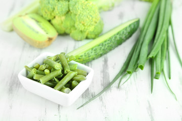 Fresh green vegetables, on wooden background