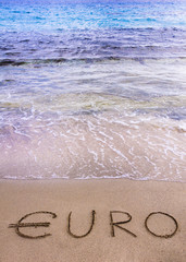 Fototapeta premium Euro word written in the sand on a beach