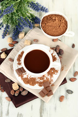 Cocoa powder in cup on napkin on wooden table