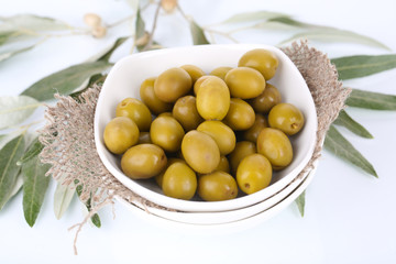 Olives in bowl with branch close up