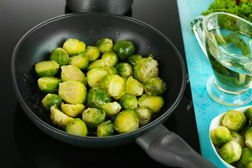 Fresh brussels sprouts in pan on cooking surface close-up