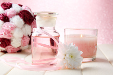 Glass bottle with color essence, on pink background