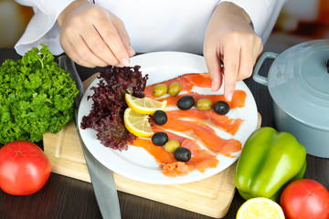 Cook hands decorating dish