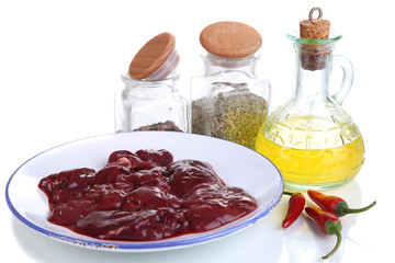 Raw liver on plate with spices and condiments isolated on white