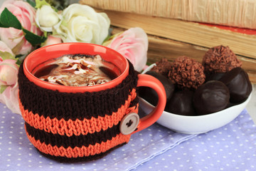 Cup with knitted thing on it close up