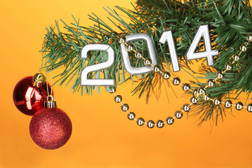 2014 hang on Christmas tree close-up on orange background