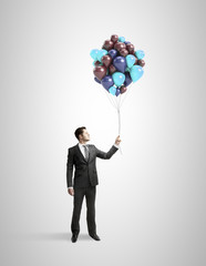 businessman holding baloons