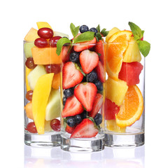 Fruit cocktails isolated. Fresh pieces of fruit in glasses