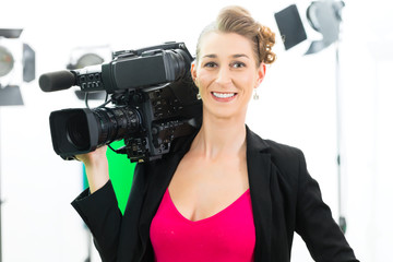 Camerawoman shooting with camera on film set