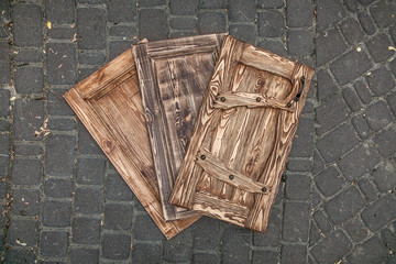 Three toned wooden doors lying on paving road