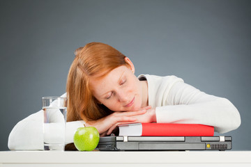 College Student Sleeping on Her Desk