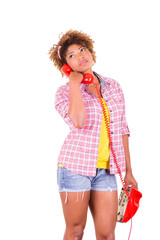 Portrait of a pretty black young woman talking on phone