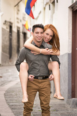 Young couple, candid shot. They are walking in the streets of