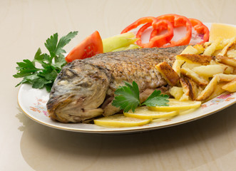 Fried carp with potato and vegetables