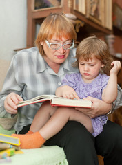 Fototapeta premium grandmother and child reads book
