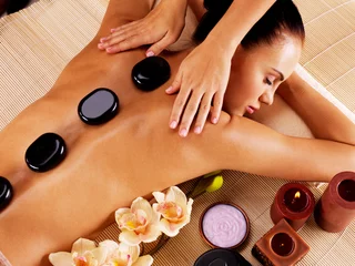 Poster Adult woman having hot stone massage in spa salon © Valua Vitaly