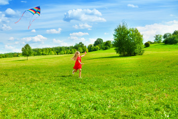 Girl running with kite