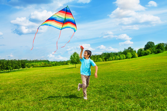 Happy boy run with kite