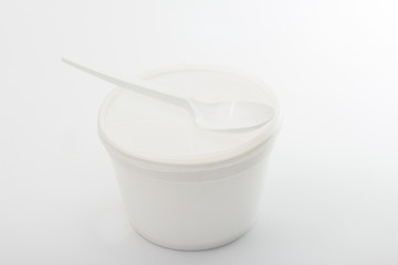 Plastic box  and spoon on white background