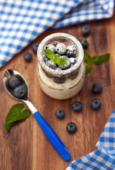 Fresh yogurt with blueberry and mint in a glass jar