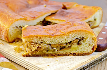 Pie with cabbage and mushrooms on the board