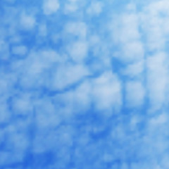 Background of fluffy white clouds on a blue sky