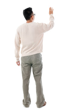 Rear view Asian man touching on transparent virtual screen