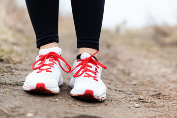 Fototapeta na wymiar Walking or running legs sport shoes