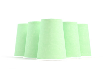 green recycling paper glasses on white background